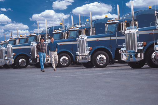 Guys walking by Trucks