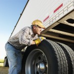 Truck driver inspects his truck.