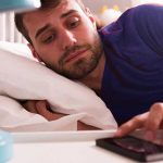 Truck driver laying on bed