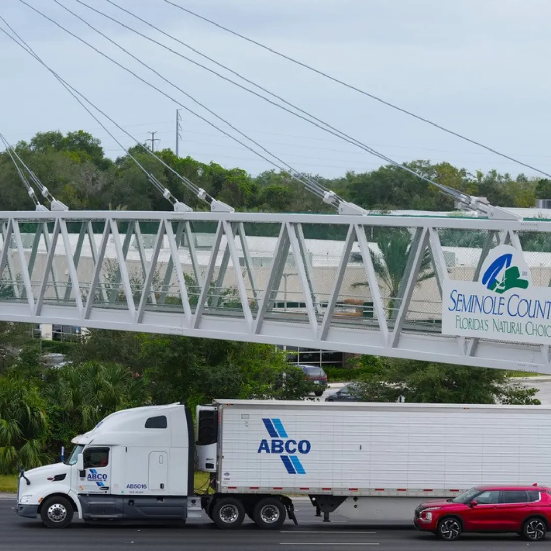 ABCO truck and trailer driving under a bridge